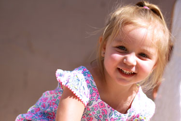 A happy little girl smiling at the camera.