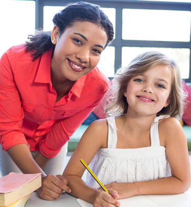 A caregiver poses with a young girl.