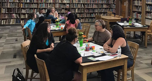 A group of parents conversing at the library.