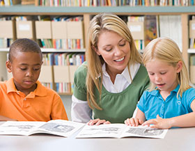 Teacher reading books to kids